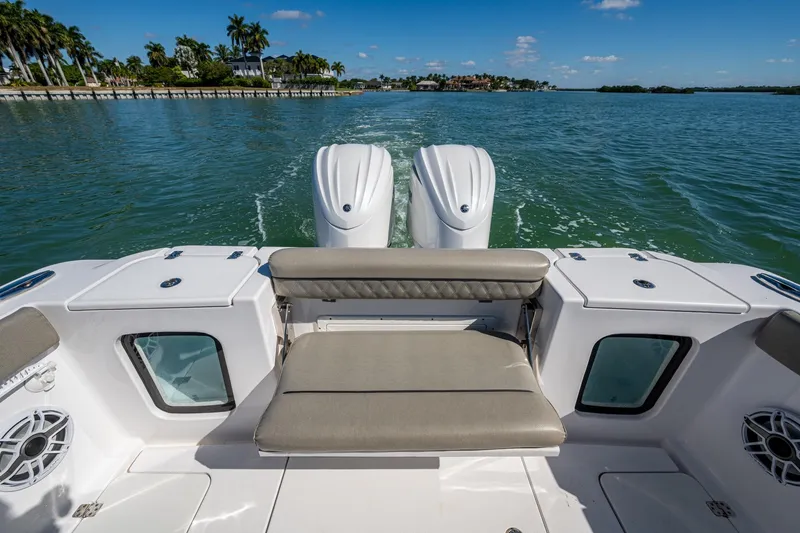  Yacht Photos Pics 2023 Sportsman Open 302 Center Console boat on water, featuring dual engines and seating.