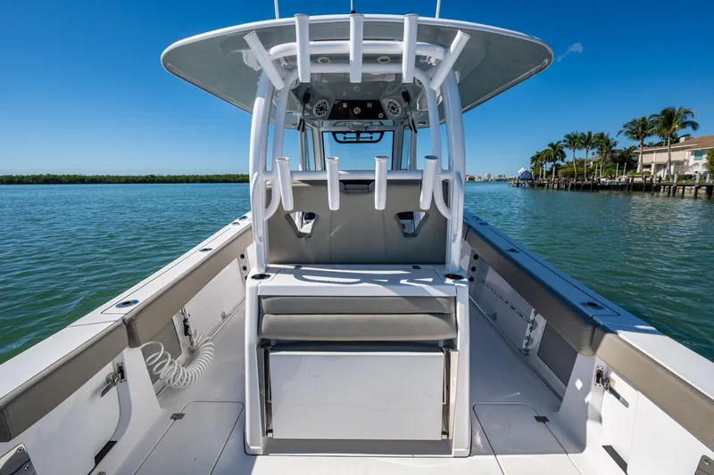  Yacht Photos Pics 2023 Sportsman Open 302 Center Console boat on calm water, showcasing spacious deck.