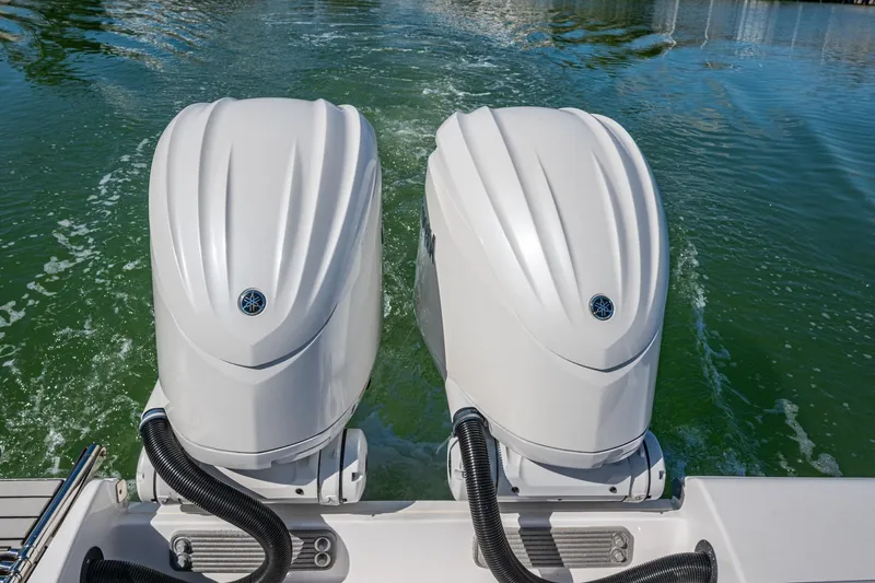  Yacht Photos Pics Twin outboard engines on 2023 Sportsman Open 302 Center Console boat in water.