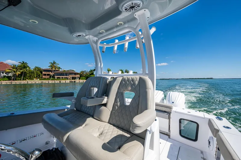  Yacht Photos Pics 2023 Sportsman Open 302 Center Console boat interior on sunny day, coastal view.
