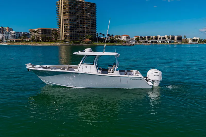  Yacht Photos Pics 2023 Sportsman Open 302 Center Console boat cruising on clear blue water.