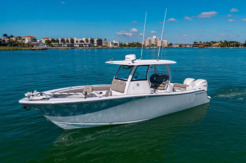 Yacht Photos Pics 2023 Sportsman Open 302 Center Console boat on clear blue water, coastal background.