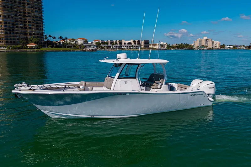  Yacht Photos Pics 2023 Sportsman Open 302 Center Console boat cruising on clear blue water.