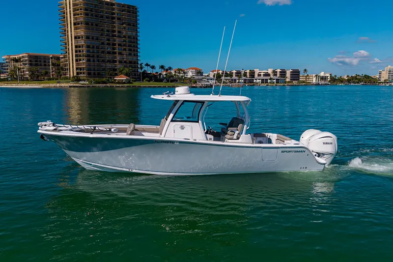  Yacht Photos Pics 2023 Sportsman Open 302 Center Console boat cruising on clear blue water.