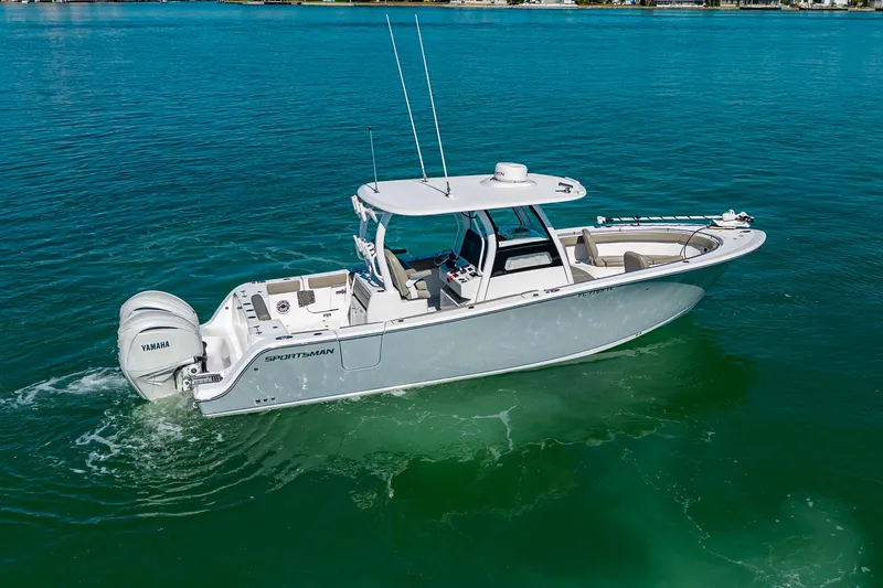  Yacht Photos Pics 2023 Sportsman Open 302 Center Console boat cruising on clear blue water.