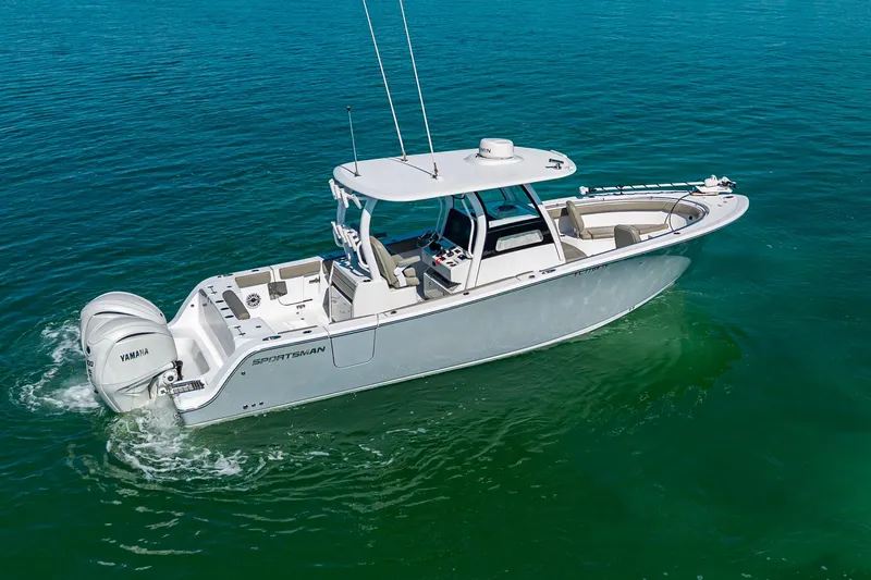  Yacht Photos Pics 2023 Sportsman Open 302 Center Console boat cruising on clear blue water.