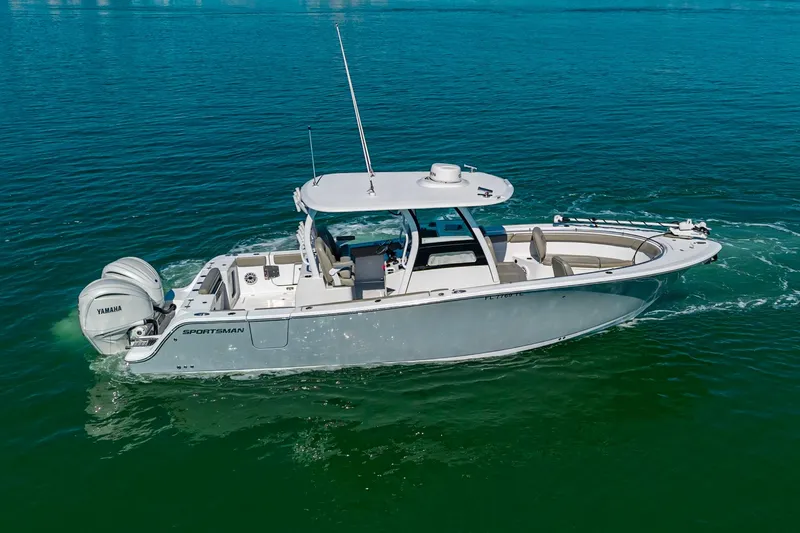  Yacht Photos Pics 2023 Sportsman Open 302 Center Console boat cruising on clear blue water.