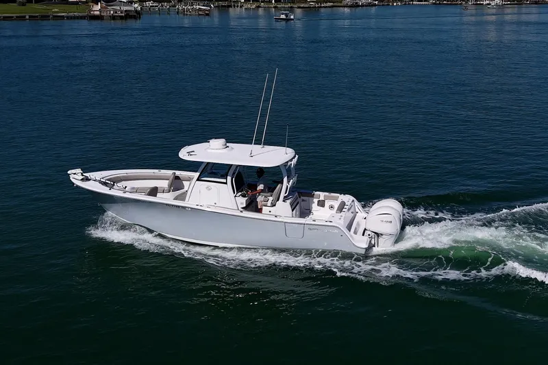  Yacht Photos Pics 2023 Sportsman Open 302 Center Console boat cruising on calm water.