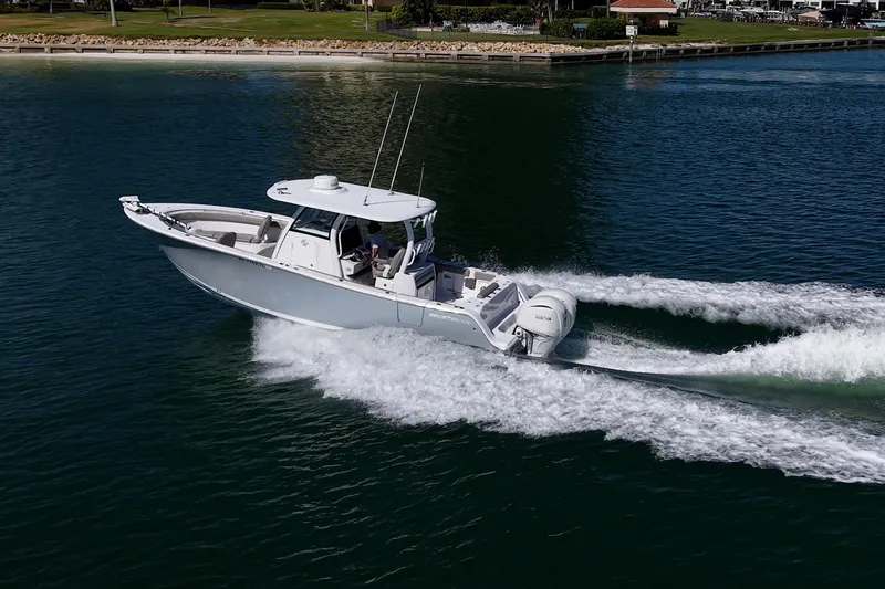  Yacht Photos Pics 2023 Sportsman Open 302 Center Console boat cruising on water.