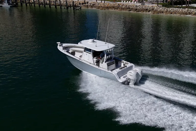  Yacht Photos Pics 2023 Sportsman Open 302 Center Console boat cruising on water.