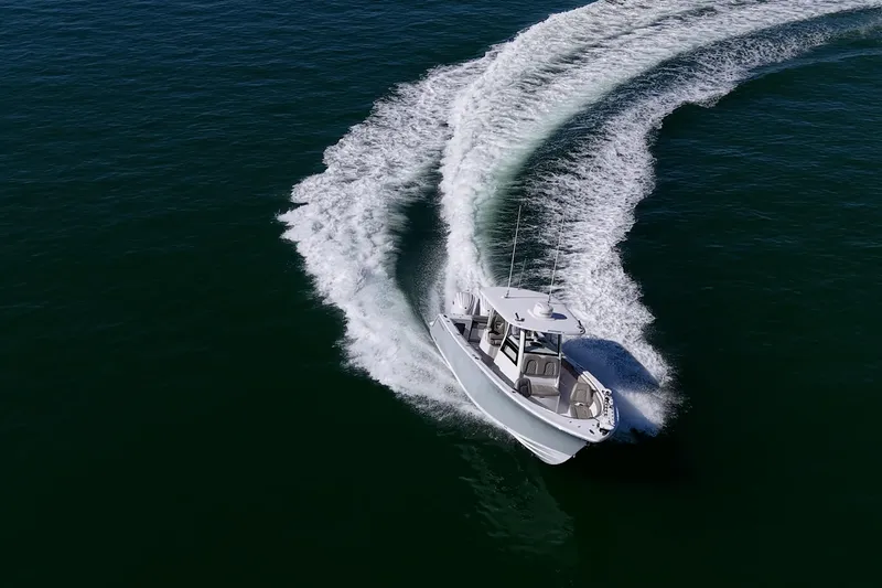  Yacht Photos Pics 2023 Sportsman Open 302 Center Console boat making a sharp turn on open water.