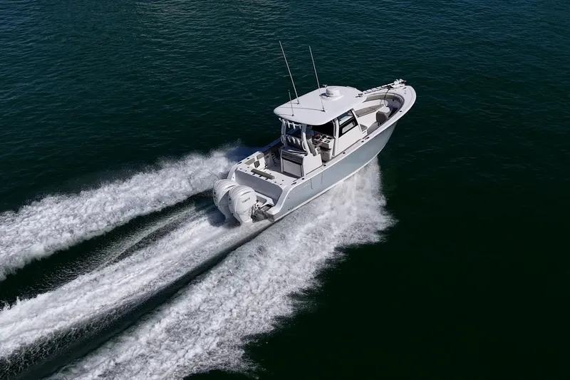  Yacht Photos Pics 2023 Sportsman Open 302 Center Console cruising on open water.