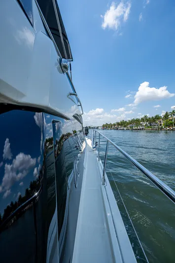 Blue B Yacht Photos Pics 2015 Beneteau Monte Carlo yacht cruising on a sunny day, reflecting blue sky and clouds.