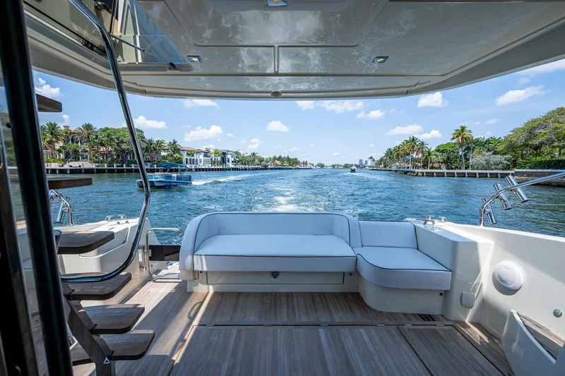 Blue B Yacht Photos Pics 2015 Beneteau Monte Carlo yacht with spacious deck, cruising on a scenic waterway.