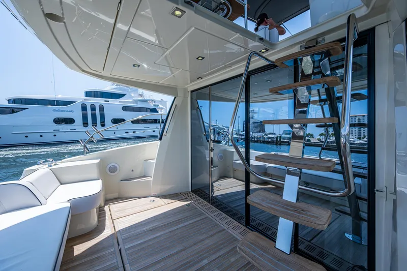 Blue B Yacht Photos Pics 2015 Beneteau MONTE CARLO yacht interior with modern staircase and seating area.