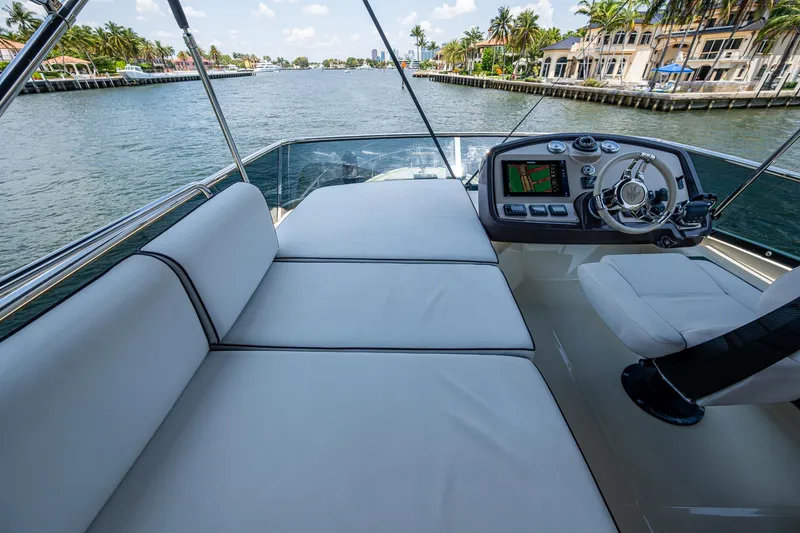 Blue B Yacht Photos Pics 2015 Beneteau Monte Carlo yacht helm with plush seating and scenic waterway view.