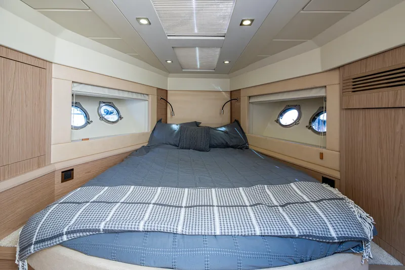 Blue B Yacht Photos Pics Luxurious cabin interior of 2015 Beneteau Monte Carlo yacht with cozy bed and porthole windows.