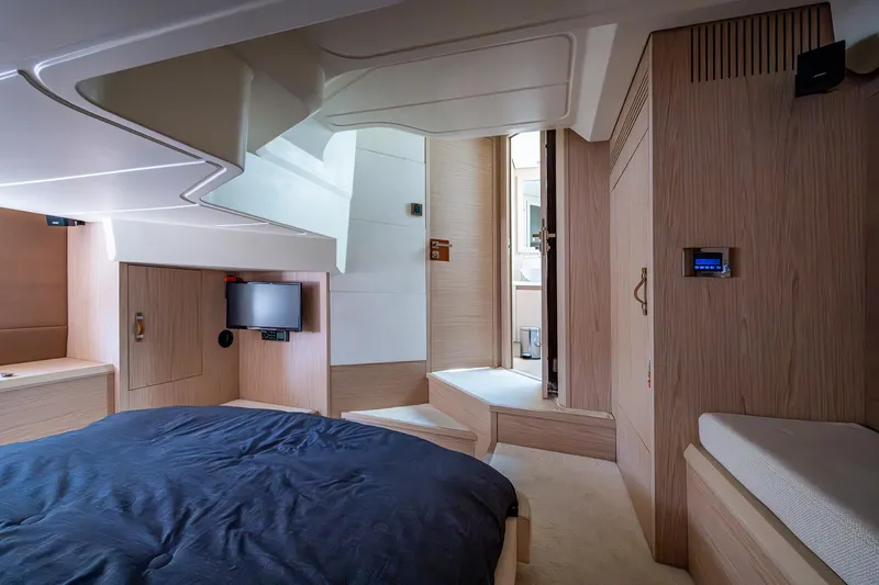 Blue B Yacht Photos Pics Luxurious interior of 2015 Beneteau Monte Carlo yacht with modern wood finish and cozy bedding.