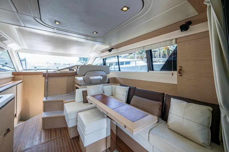 Blue B Yacht Photos Pics Luxurious interior of 2015 Beneteau Monte Carlo yacht with modern seating and wood finishes.