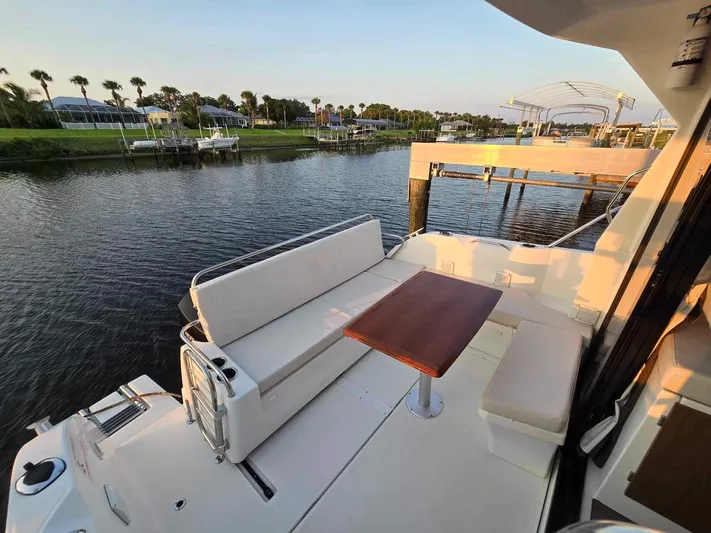  Yacht Photos Pics 2020 Beneteau Antares 9 OB boat with seating area and table on deck.