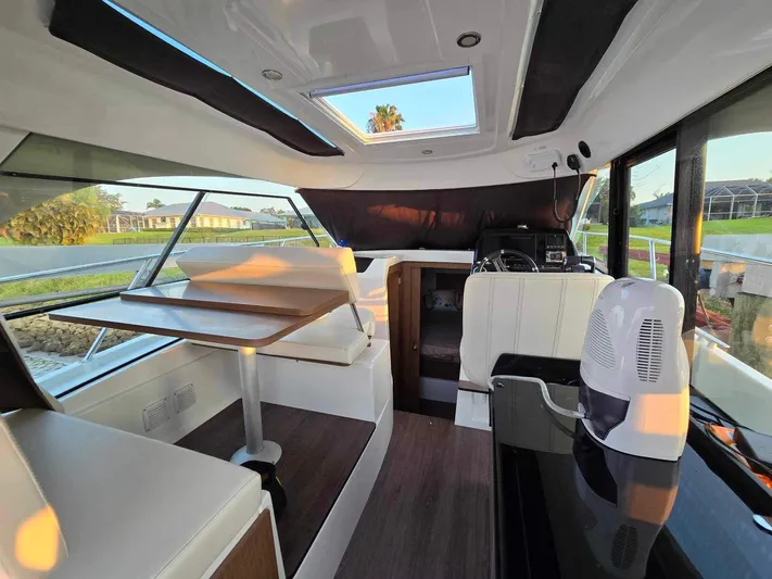  Yacht Photos Pics Interior of 2020 Beneteau Antares 9 OB boat with seating and table.