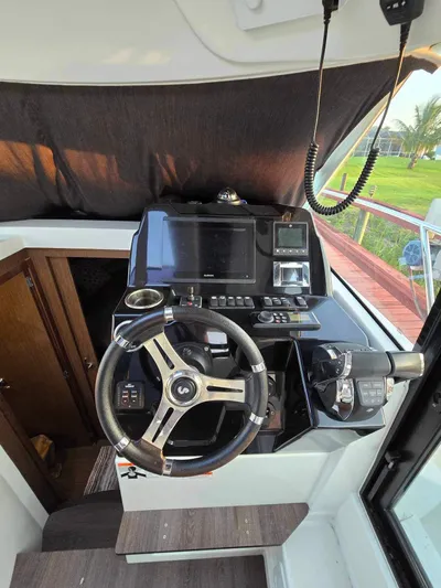  Yacht Photos Pics 2020 Beneteau Antares 9 OB helm with modern controls and navigation equipment.