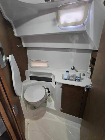  Yacht Photos Pics 2020 Beneteau Antares 9 OB boat bathroom with toilet, sink, and storage.