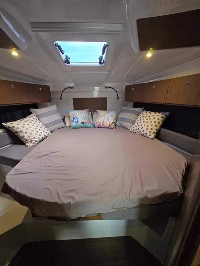  Yacht Photos Pics 2020 Beneteau Antares 9 OB cabin with cozy bedding and decorative pillows.