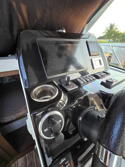  Yacht Photos Pics Control panel of 2020 Beneteau Antares 9 OB boat with steering wheel and navigation screen.