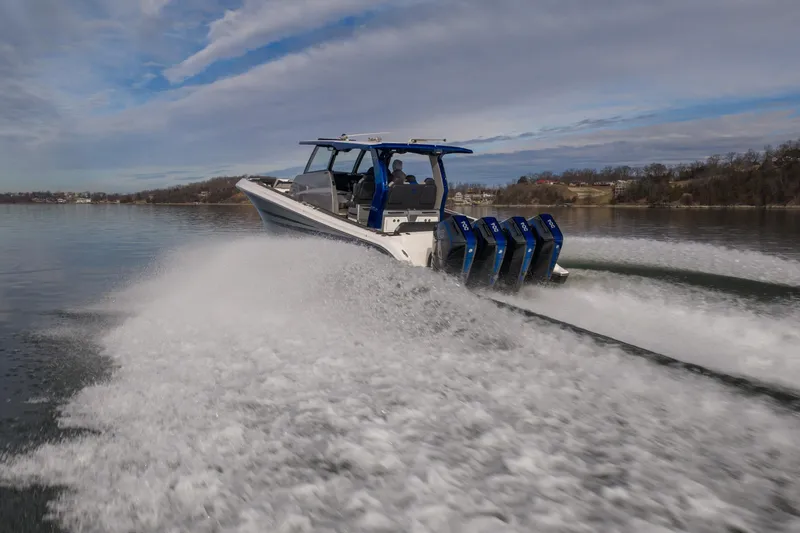  Yacht Photos Pics 2025 Fountain 43 SCX speedboat cruising on a lake with powerful engines.