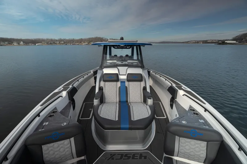  Yacht Photos Pics 2025 Fountain 43 SCX boat interior with luxurious seating on a calm lake.