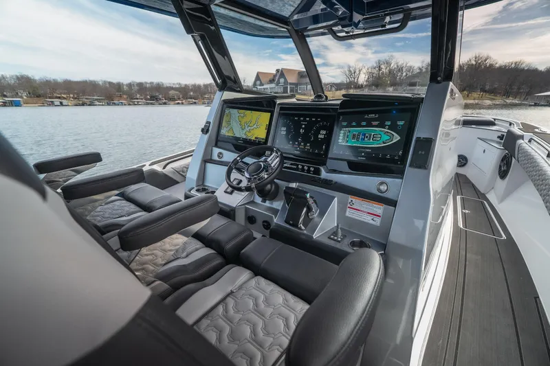  Yacht Photos Pics 2025 Fountain 43 SCX boat interior with advanced navigation and control systems on a serene lake.