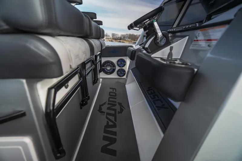  Yacht Photos Pics 2025 Fountain 43 SCX boat interior with steering wheel and seating, showcasing modern design.