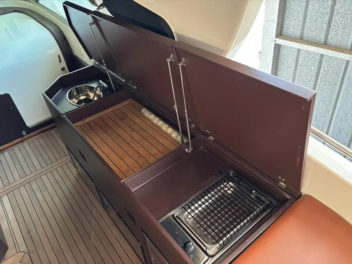  Yacht Photos Pics 1998 Cantieri di Sarnico MAXIM 55 SPECIAL yacht interior with kitchenette and wooden flooring.