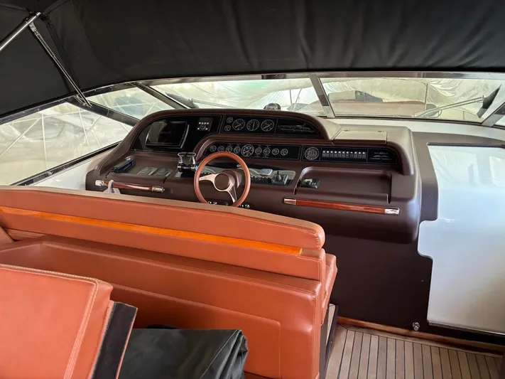  Yacht Photos Pics 1998 Cantieri di Sarnico MAXIM 55 SPECIAL yacht cockpit with leather seating and wooden steering wheel.