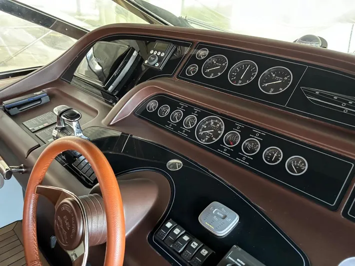  Yacht Photos Pics Control panel of 1998 Cantieri di Sarnico MAXIM 55 SPECIAL yacht with gauges and steering wheel.