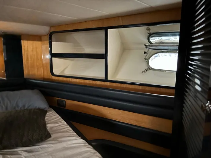  Yacht Photos Pics Interior cabin of 1998 Cantieri di Sarnico MAXIM 55 SPECIAL yacht, featuring wood paneling and bedding.