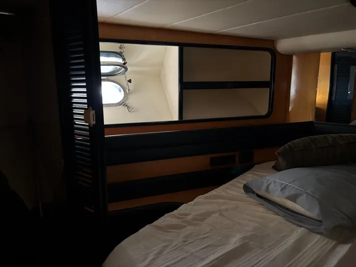  Yacht Photos Pics Interior cabin of 1998 Cantieri di Sarnico MAXIM 55 SPECIAL yacht, featuring bed and porthole.
