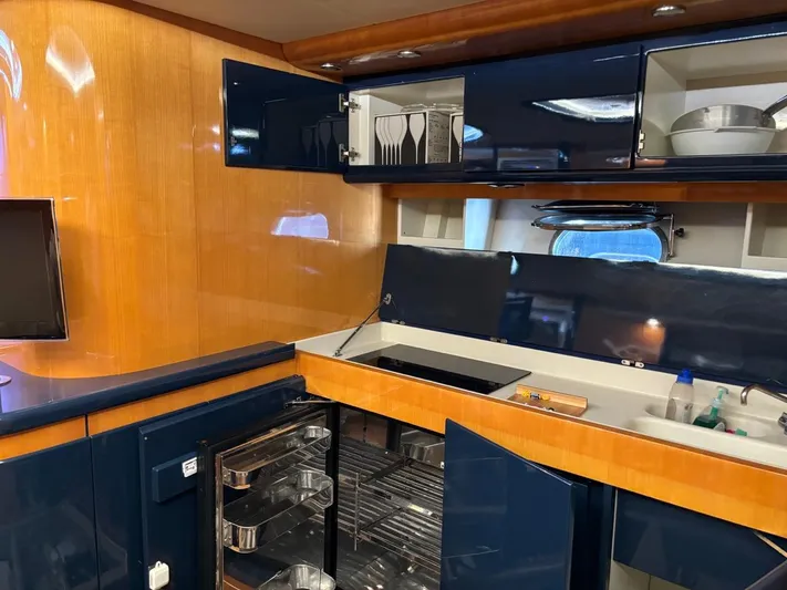  Yacht Photos Pics Interior of 1998 Cantieri di Sarnico MAXIM 55 SPECIAL yacht kitchen with blue cabinets.