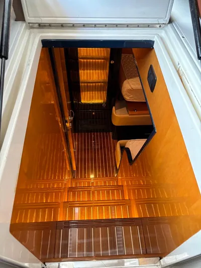  Yacht Photos Pics Interior view of 1998 Cantieri di Sarnico MAXIM 55 SPECIAL yacht, featuring warm lighting and wooden flooring.