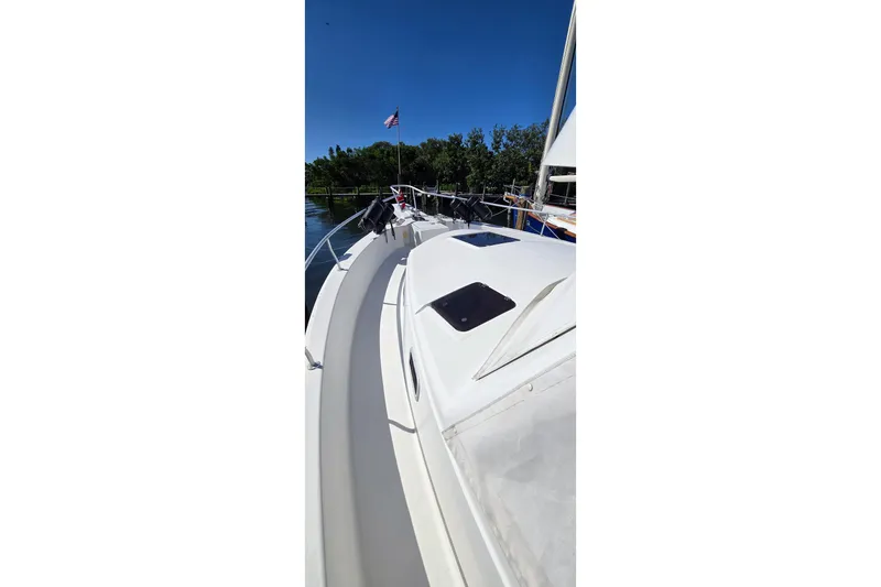Polly Yacht Photos Pics 2000 Mainship 390 Trawler deck view with clear sky and water background.