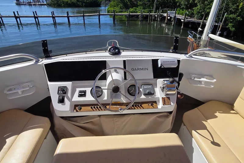 Polly Yacht Photos Pics 2000 Mainship 390 Trawler helm with Garmin navigation, dockside view.