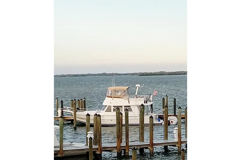 Polly Yacht Photos Pics 2000 Mainship 390 Trawler docked at a marina with calm waters.