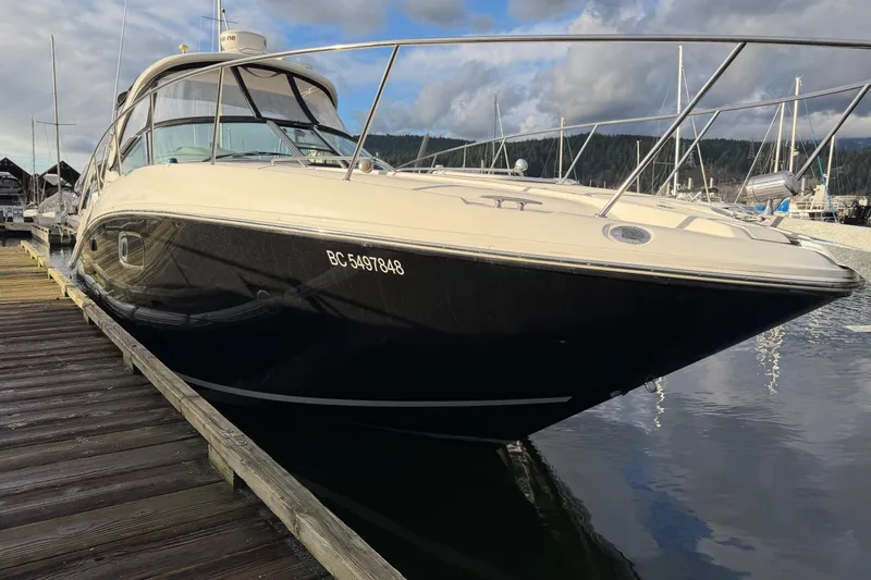 Finding Time Yacht Photos Pics 2011 Sea Ray 350 Sundancer docked at a marina, reflecting on calm water.