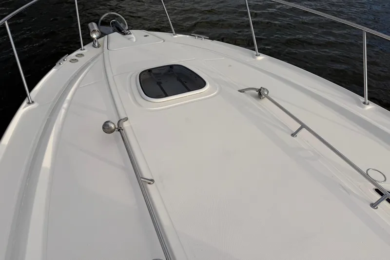 Finding Time Yacht Photos Pics 2011 Sea Ray 350 Sundancer boat deck with hatch, on calm water.