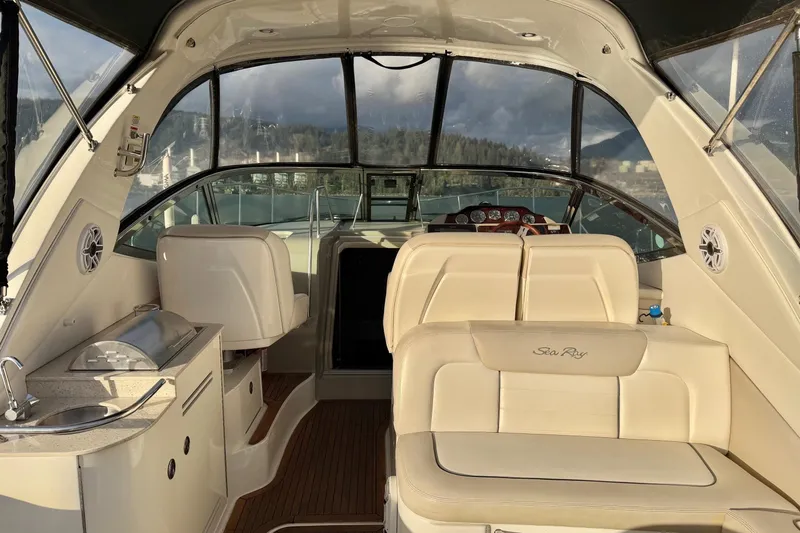 Finding Time Yacht Photos Pics Interior of 2011 Sea Ray 350 Sundancer boat with seating and helm.