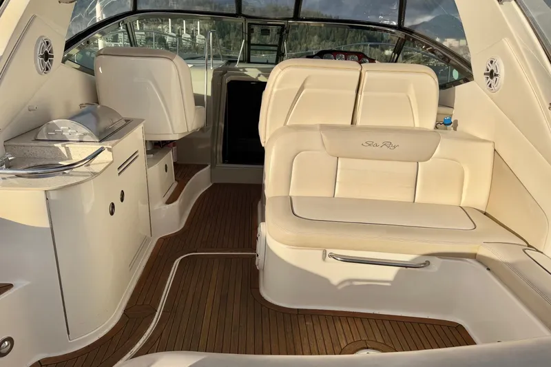 Finding Time Yacht Photos Pics Interior of 2011 Sea Ray 350 Sundancer with beige seating and wooden flooring.