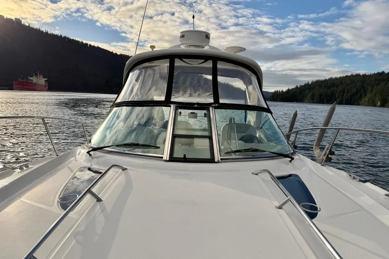 Finding Time Yacht Photos Pics 2011 Sea Ray 350 Sundancer yacht on scenic water with forested hills.