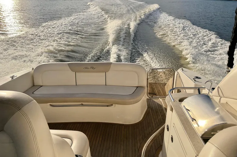 Finding Time Yacht Photos Pics 2011 Sea Ray 350 Sundancer cruising, showcasing luxurious seating and wake trail.