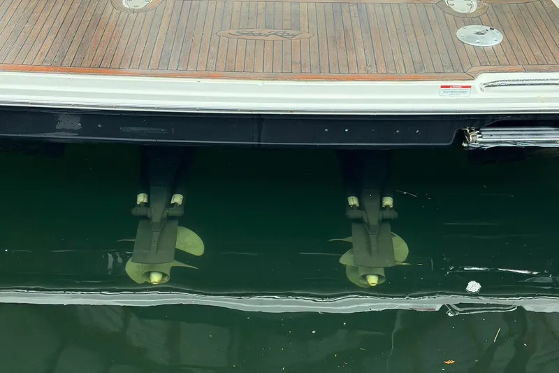 Finding Time Yacht Photos Pics 2011 Sea Ray 350 Sundancer stern with propellers submerged in water.